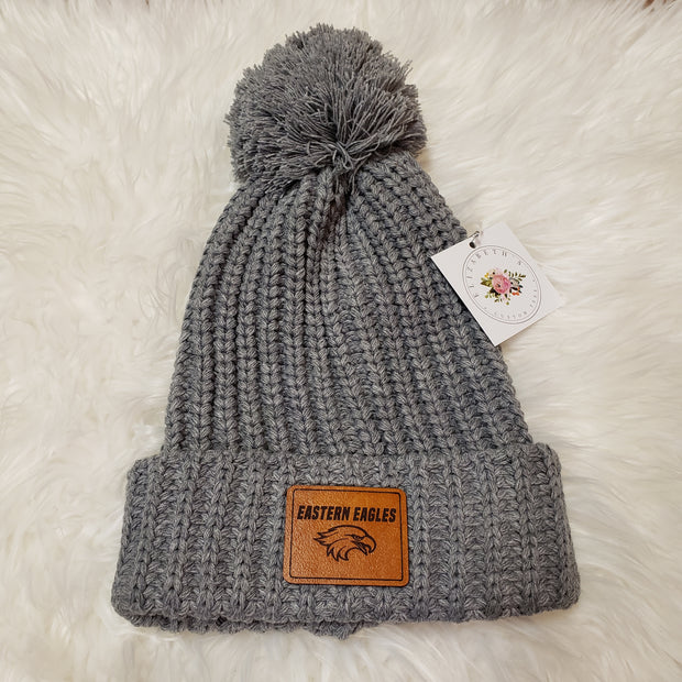 Grey Pom Pom Beanies with Leather Patch Attached